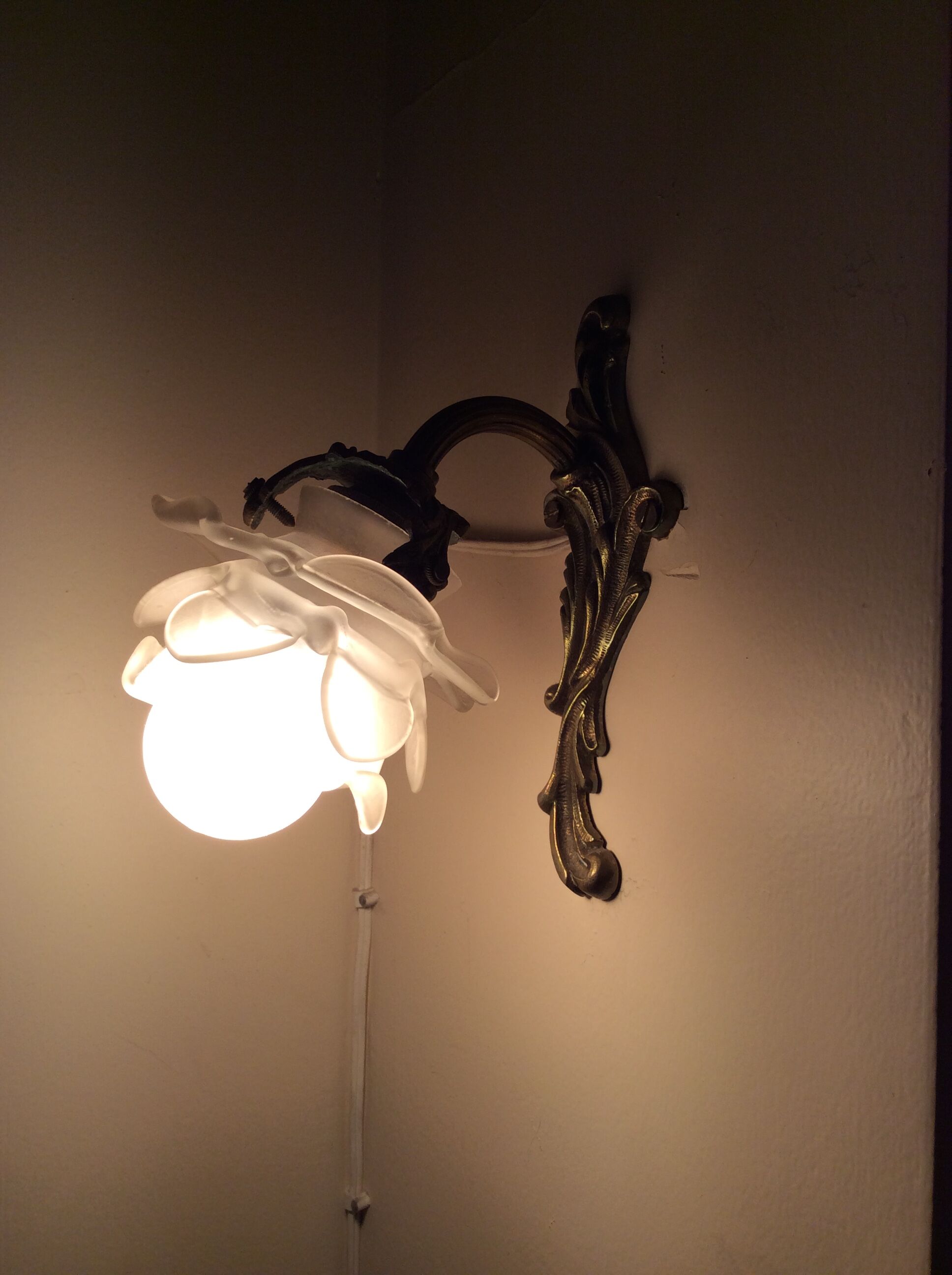 Old wall lamp in bronze and glass
