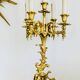 Massive gilded bronze chandeliers from the mid-20th century with marble bases.
