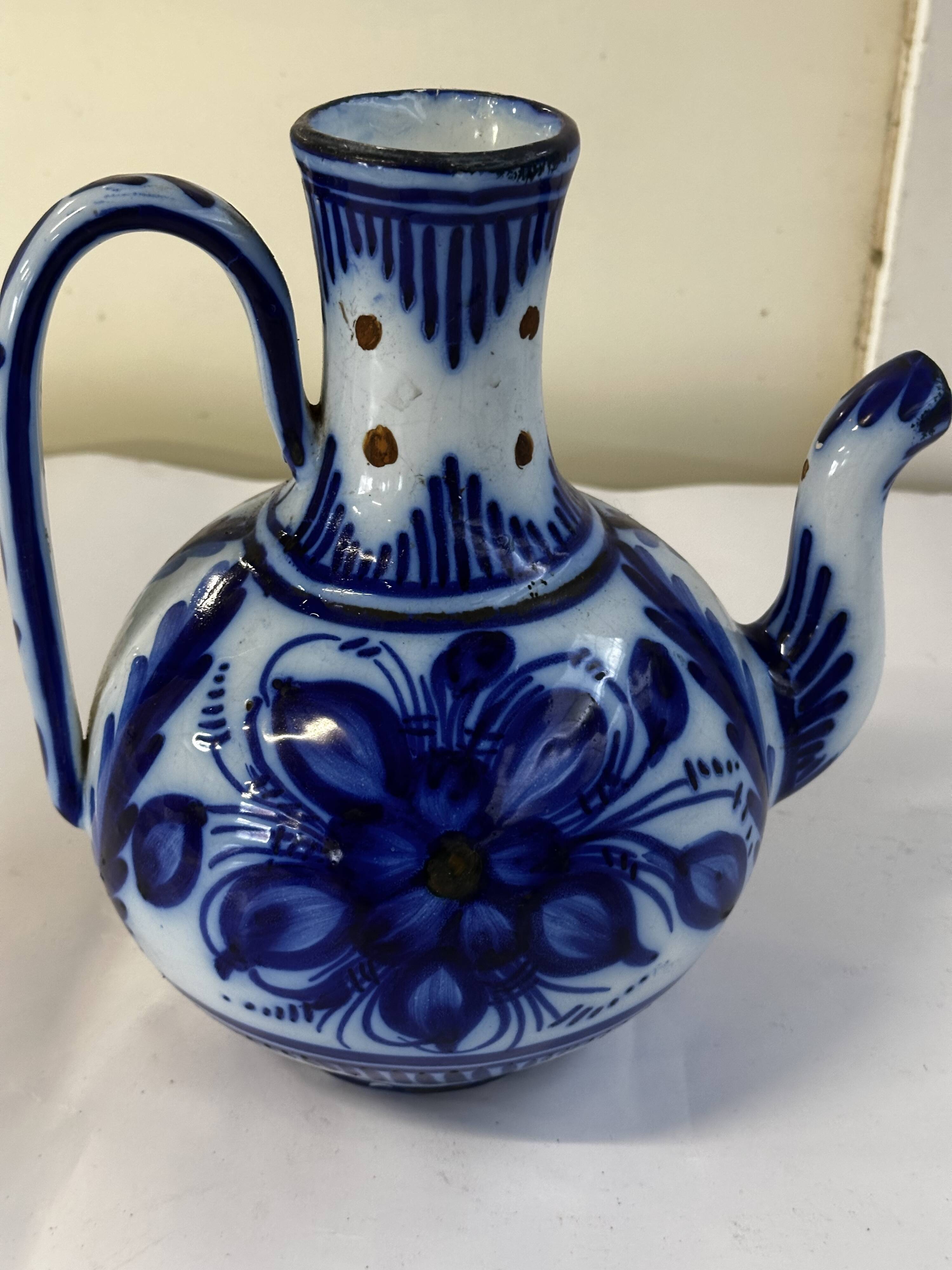 Glazed ceramic carafe with floral decoration