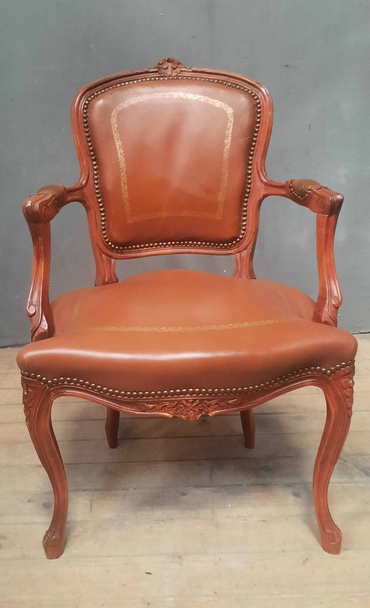 Louis XV style armchair covered in leather.