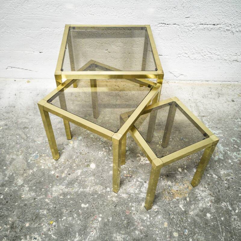 Trio of nesting tables in brass and smoked glass