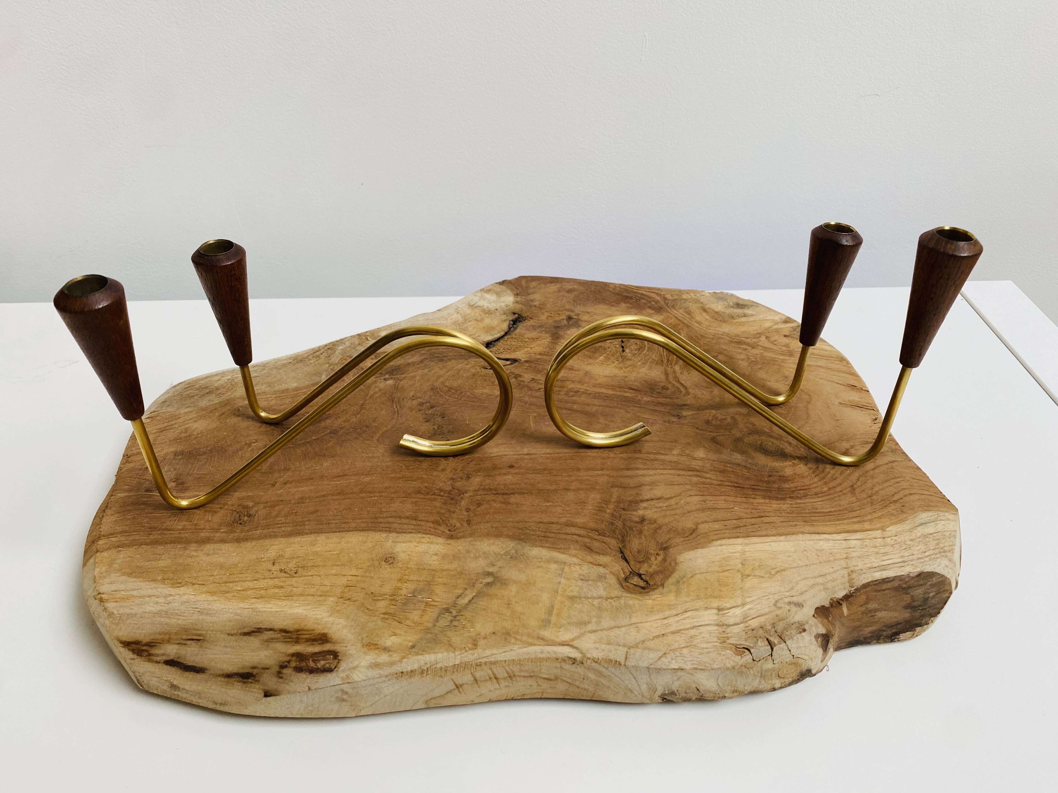 Pair of teak and brass candlesticks