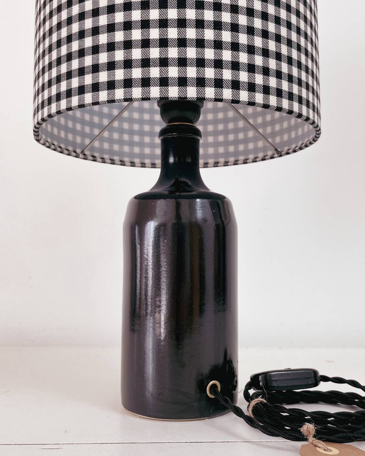 Black earthenware lamp and gingham lampshade