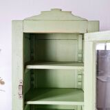 Small glass cabinet in green colour.