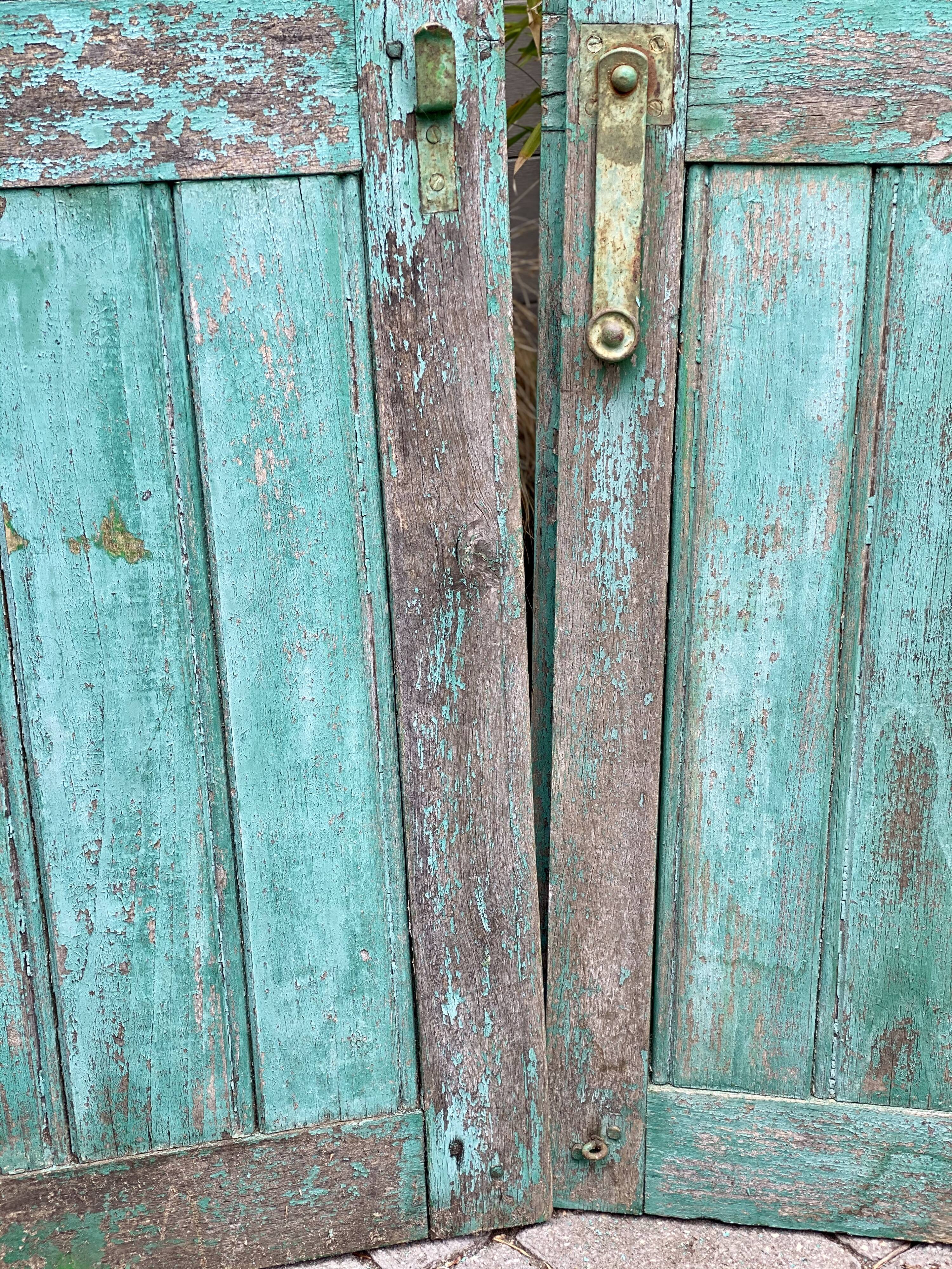 Pair of old wooden shutters green mint color