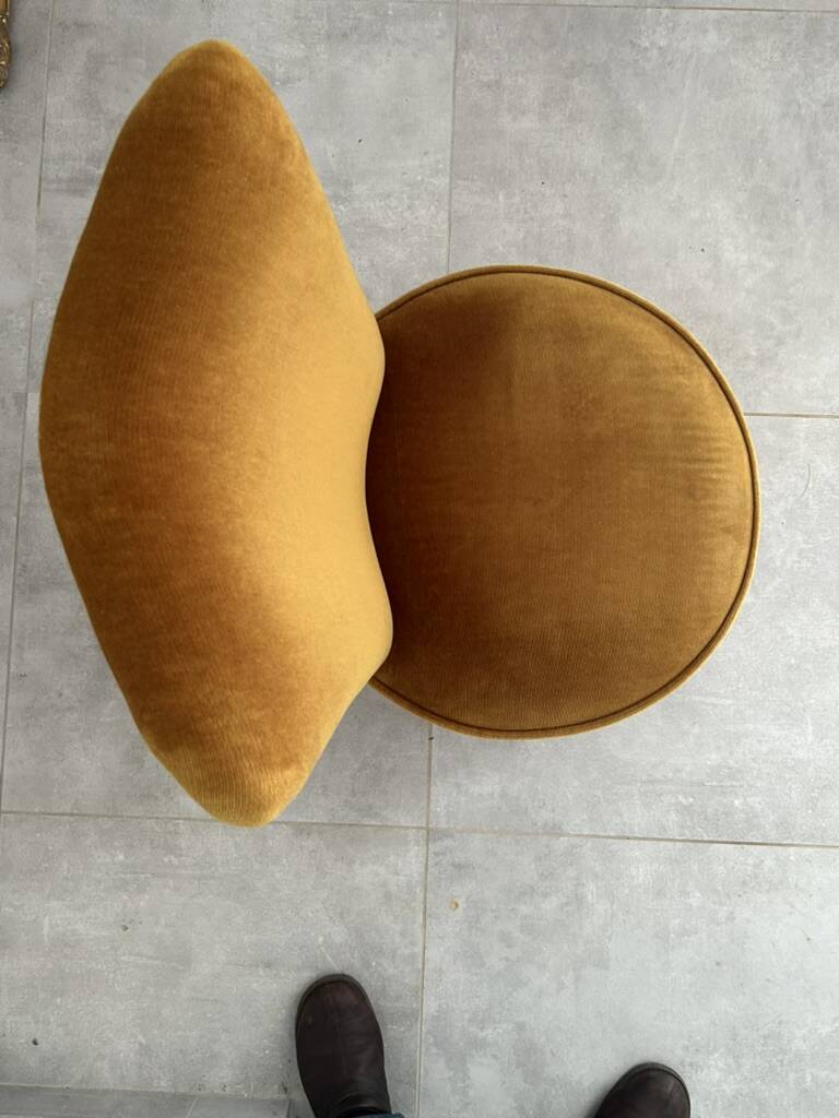 Ochre and fringed pouffe-style armchair