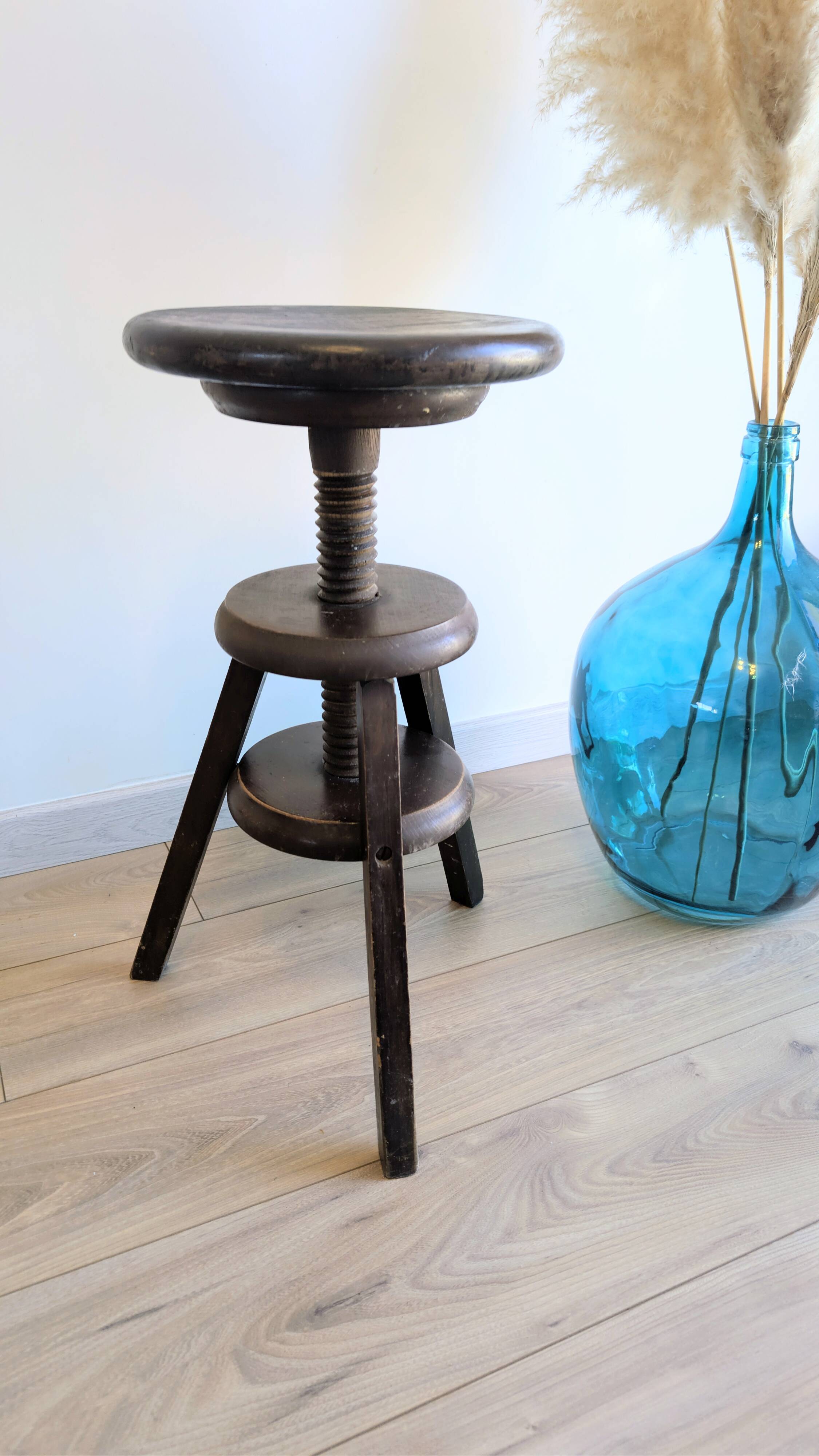 Antique wooden watchmaker's stool with screws, patinated wood.