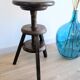 Antique wooden watchmaker's stool with screws, patinated wood.