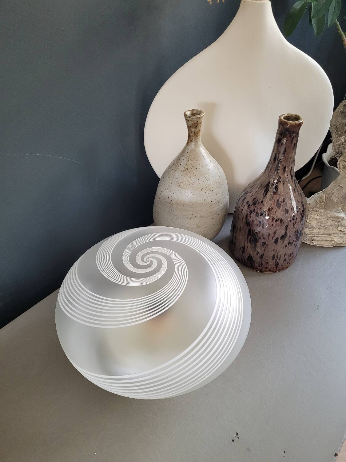 Frosted glass globe ceiling light with spiral patterns.