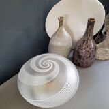 Frosted glass globe ceiling light with spiral patterns.