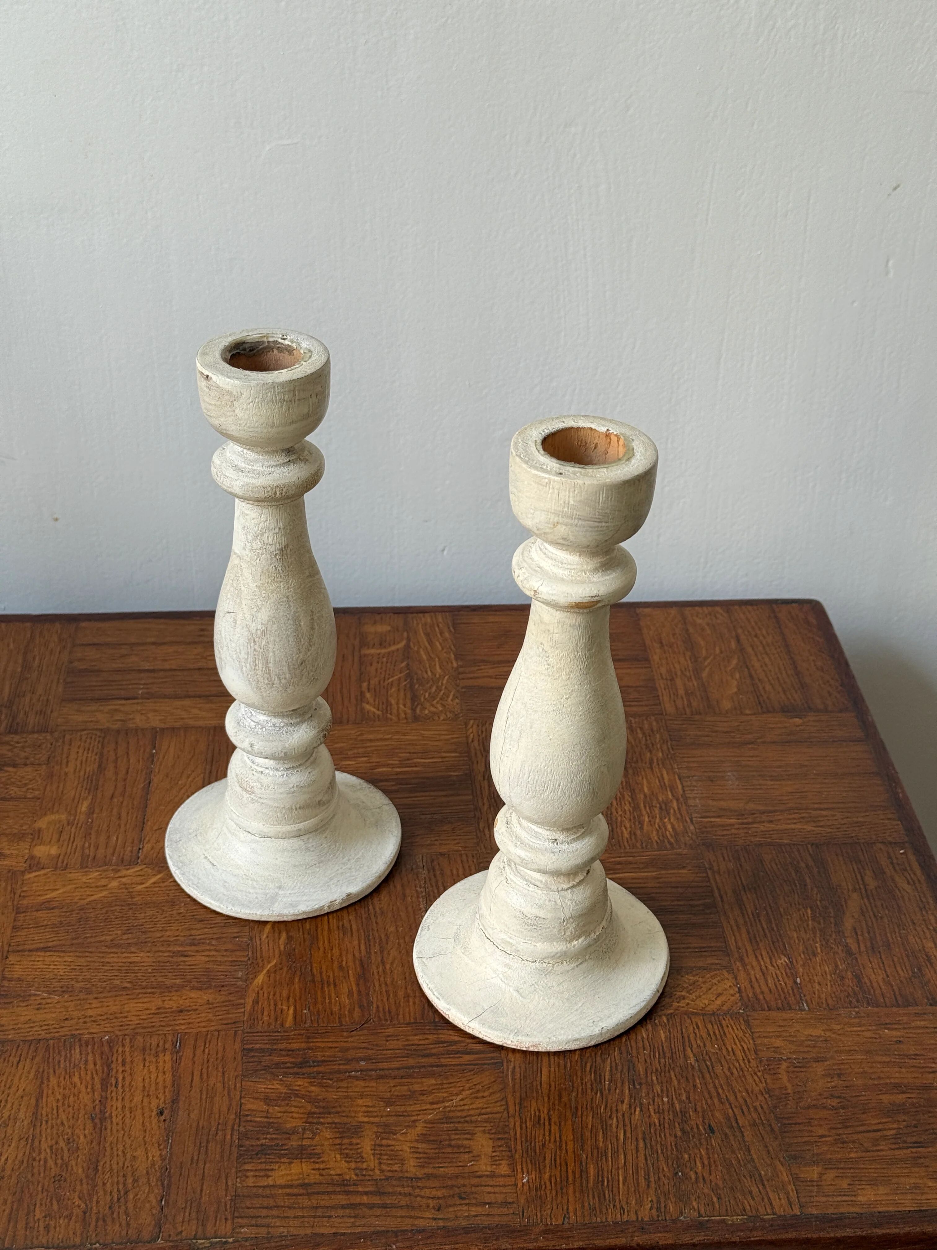 Pair of white wooden candlesticks