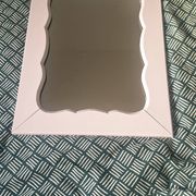 Mid-20th century rectangular wall mirror with a powder pink frame.