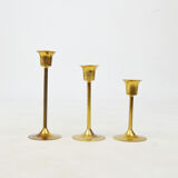 A set of three golden candlesticks, 1970s