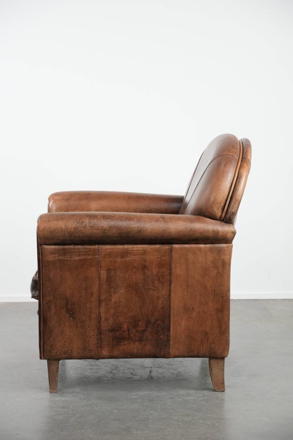 Beautiful vintage sheep leather armchair with a characterful appearance