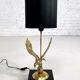 Brass lamp on black lacquered wooden base