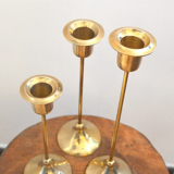 Trio of brass candlesticks