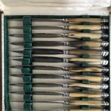 Twelve Art Deco horn and silver knives