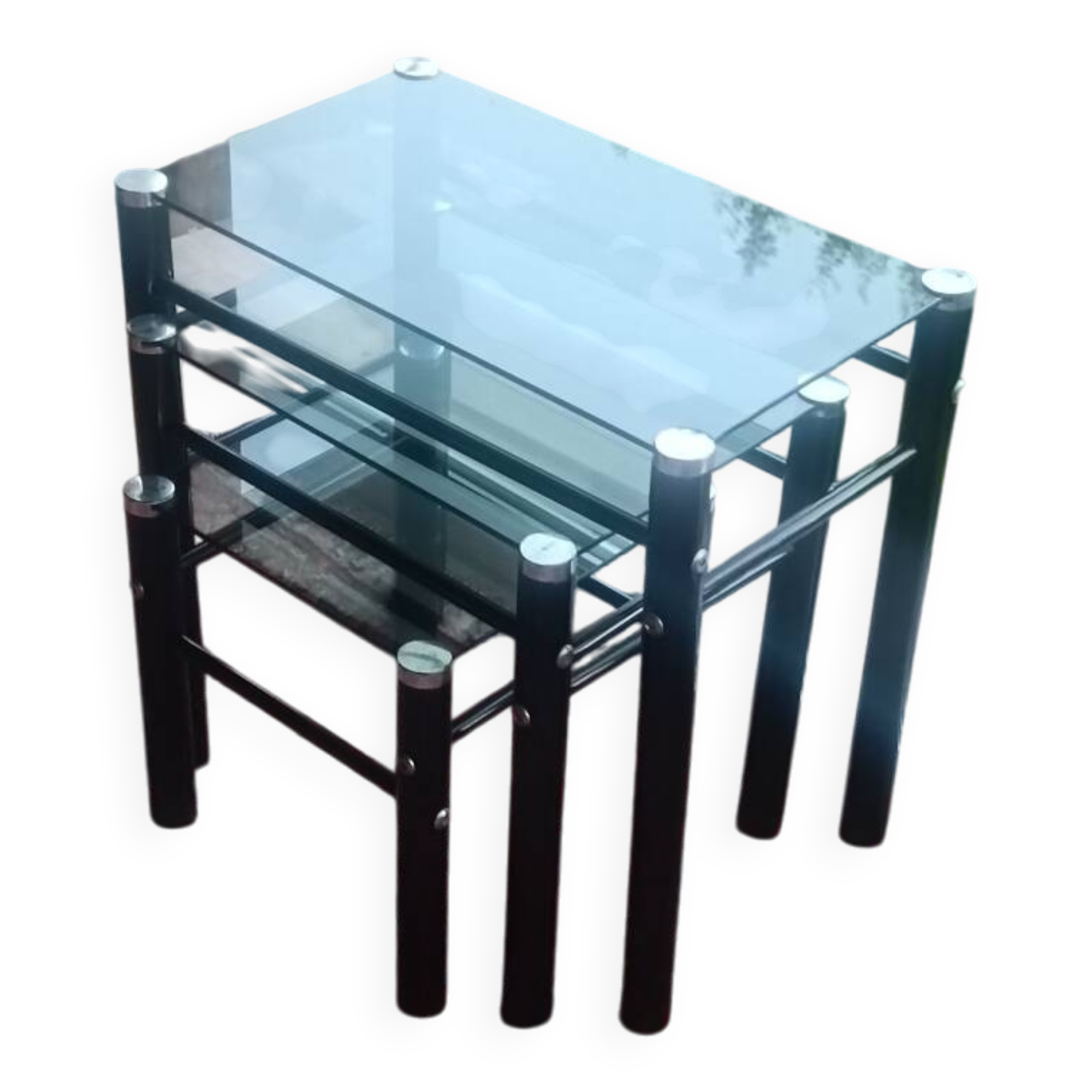 3 nesting tables in black metal with smoked glass tops.