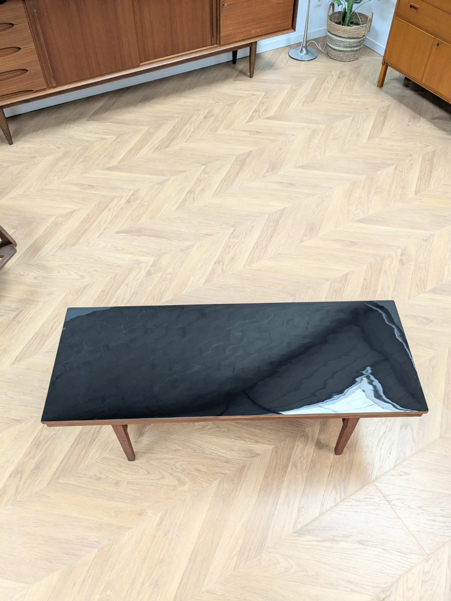 Vintage Danish coffee table in teak with a black top from the 1960s.