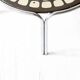 Black and white round coffee table with a mandala top and chrome metal base.
