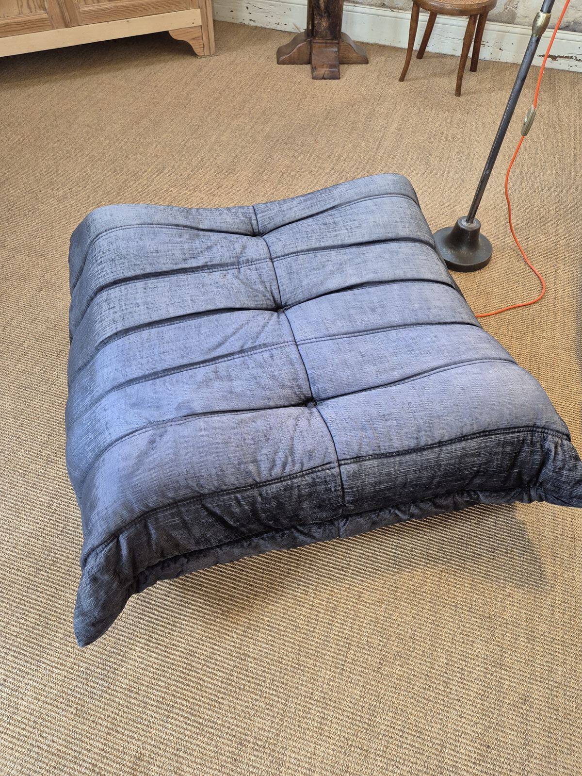 Togo sofa by Ligne Roset and its pouf from the 1970s.