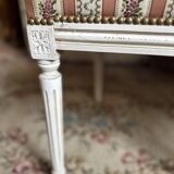 Pair of Louis XVI style chairs in painted wood and satin, classic elegance.