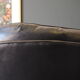 Chesterfield style leather armchair & footstool by Hancock & Moore