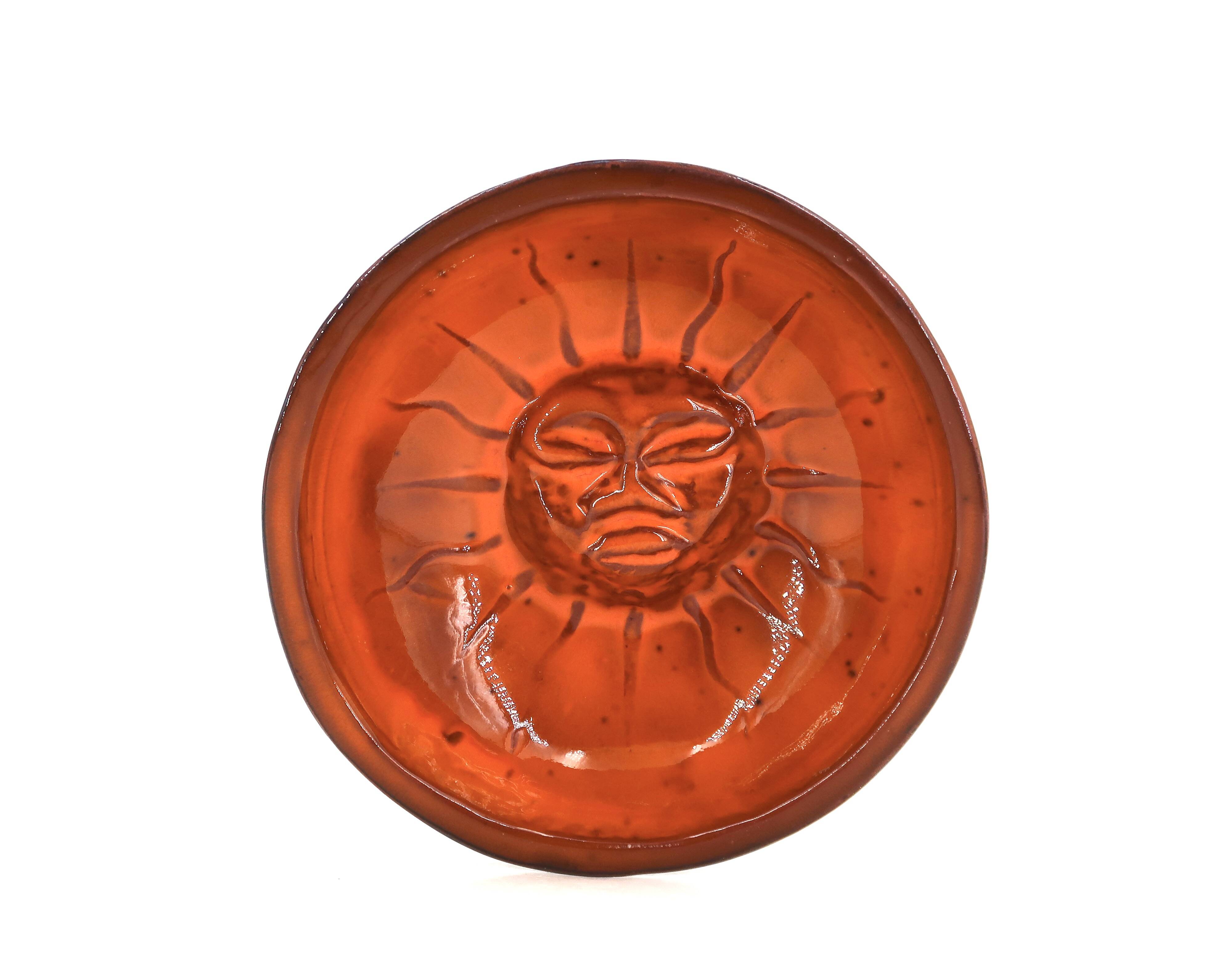 Mexican ceramic catchall in orange and black, 1970s sun face.