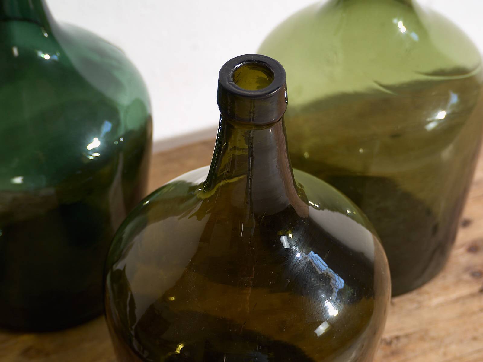 Antique green demijohns (circa 1920). Set of 3 pieces