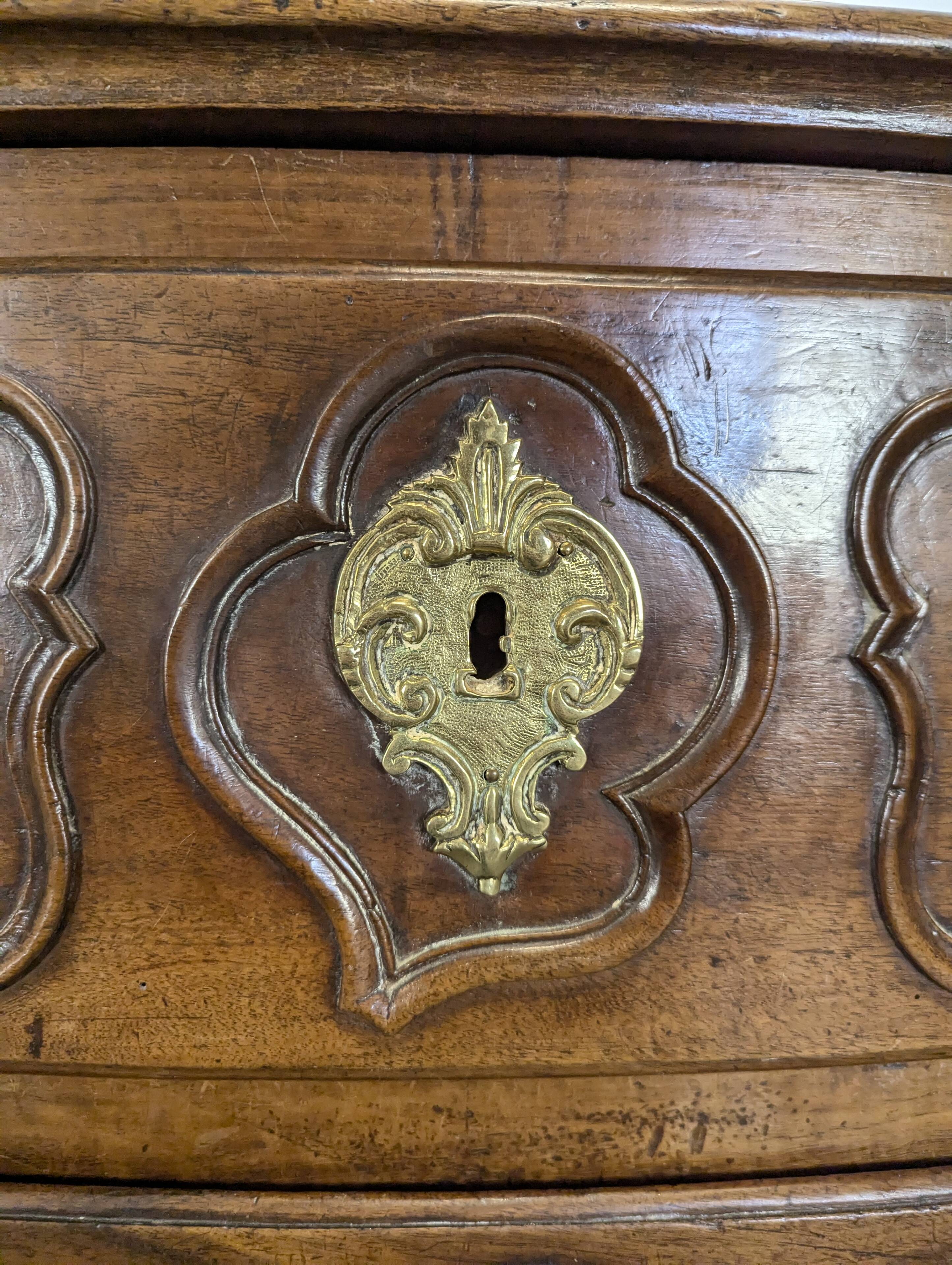 18th century Lyonnaise chest of drawers in carved walnut and bronze