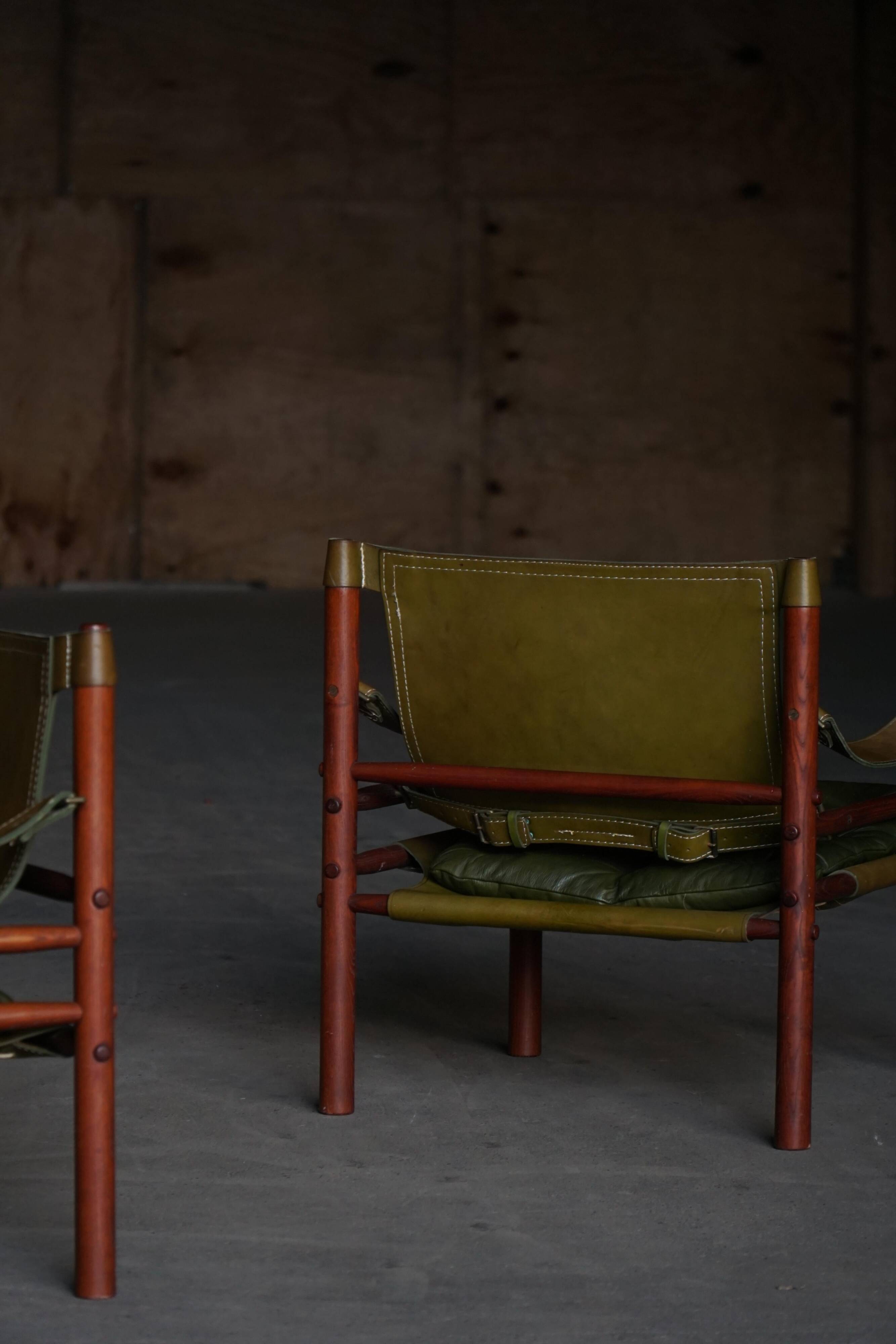 Arne Norell, Pair of "Sirocco" Safari armchairs in ash and green leather, 1960s.