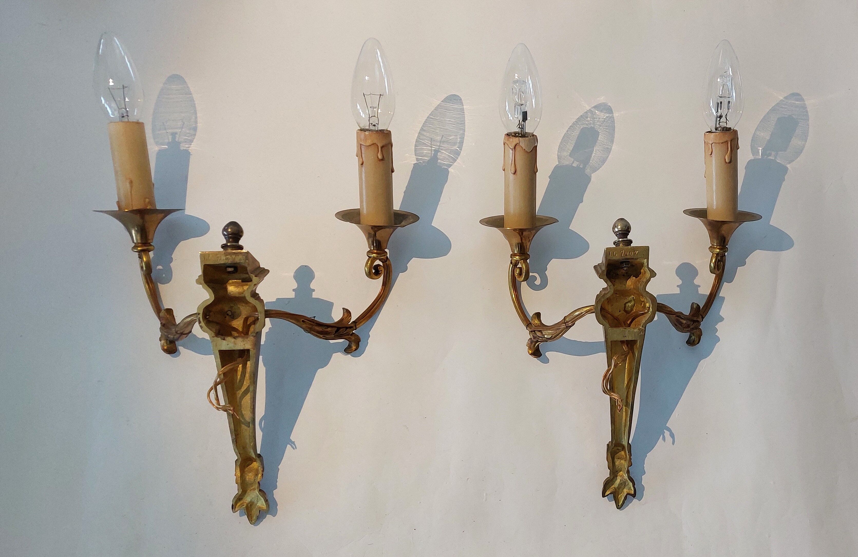 Pair of neoclassical sconces in bronze and gilded brass 1950.