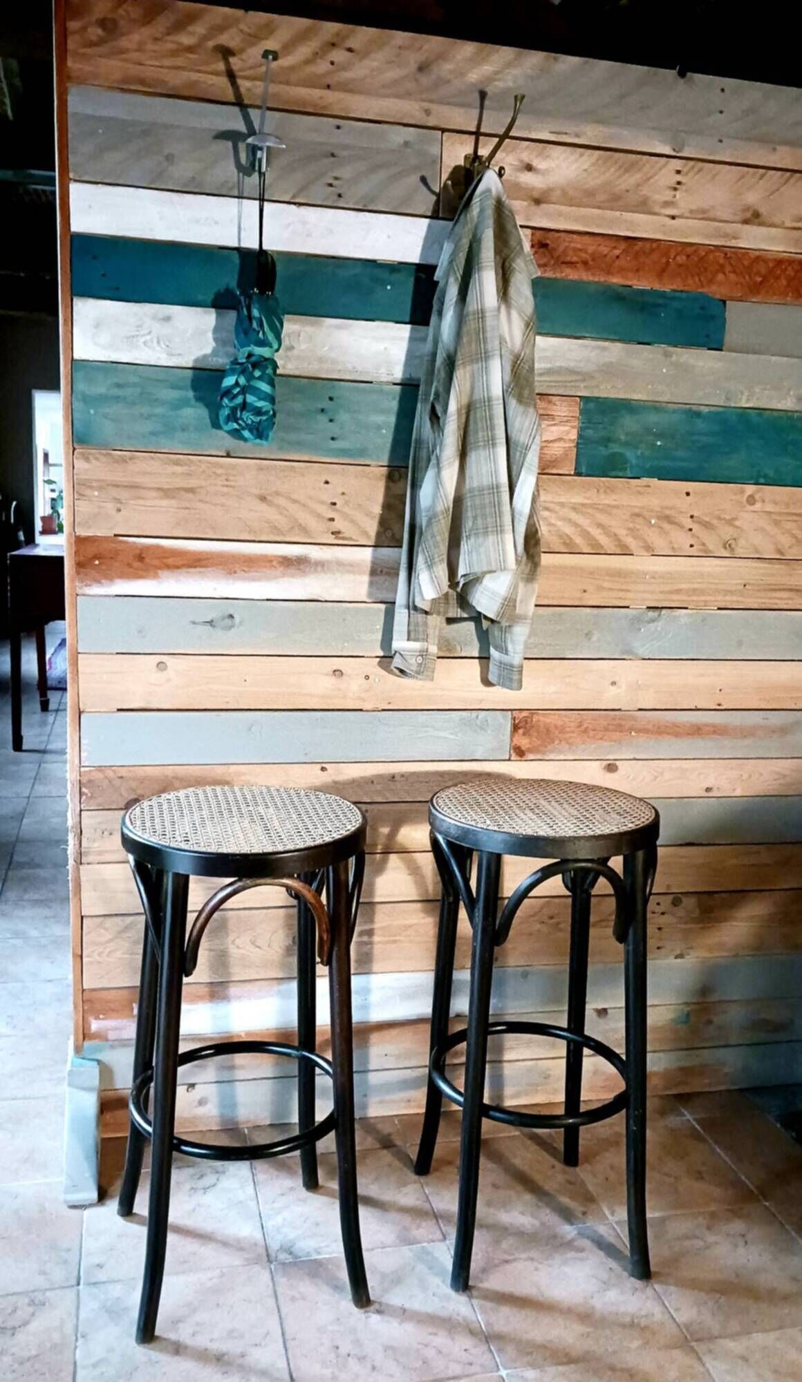 Set of 2 high bar stools made of wicker and rattan cane.