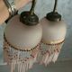 Paire d’appliques murales en verre rose et pampilles