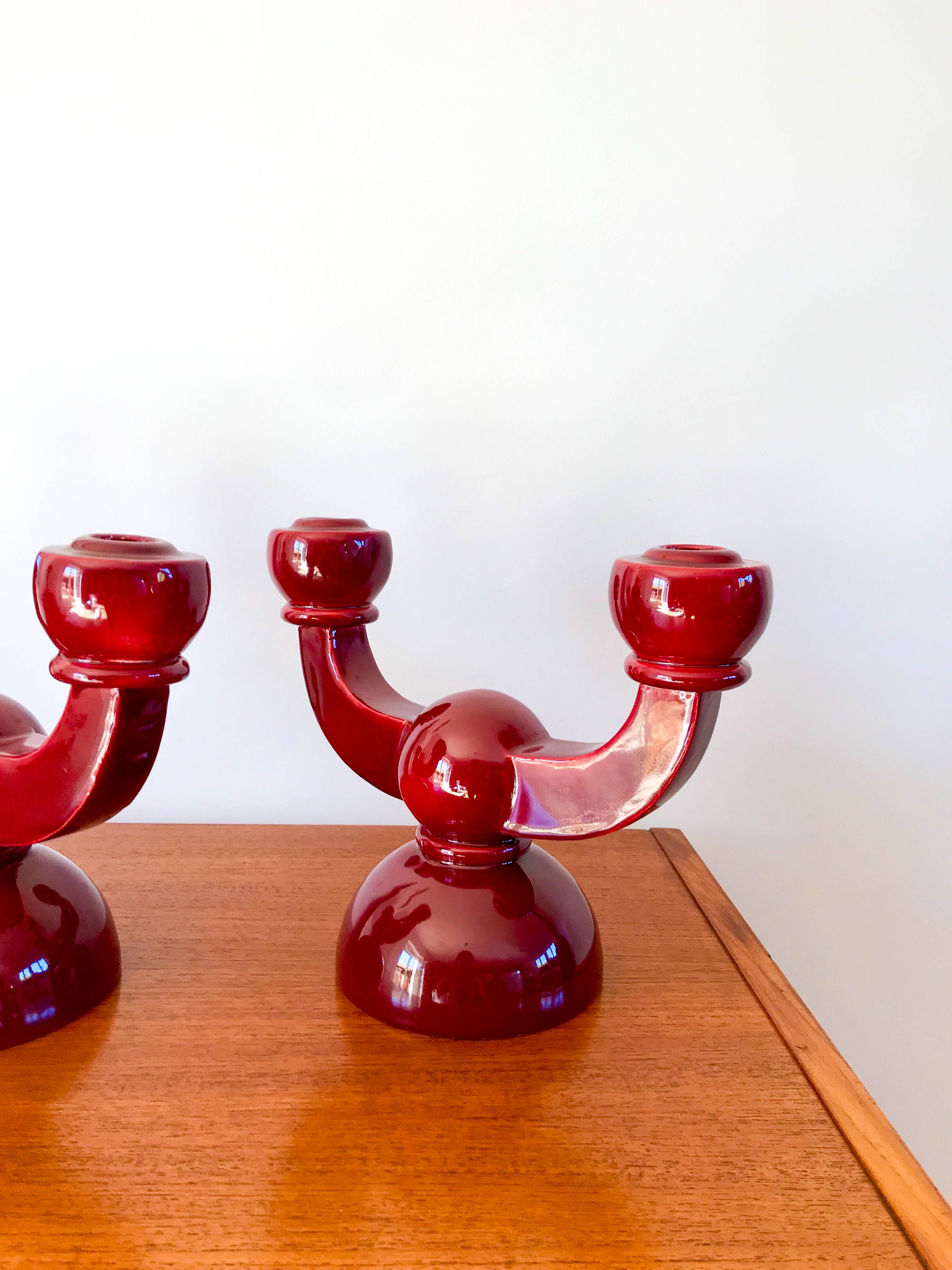 pair of burgundy enameled ceramic candlesticks / candelabras signed 1949