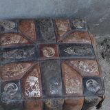Set of 2 vintage ottomans in brown and black leather with Egyptian patterns from the 1970s.