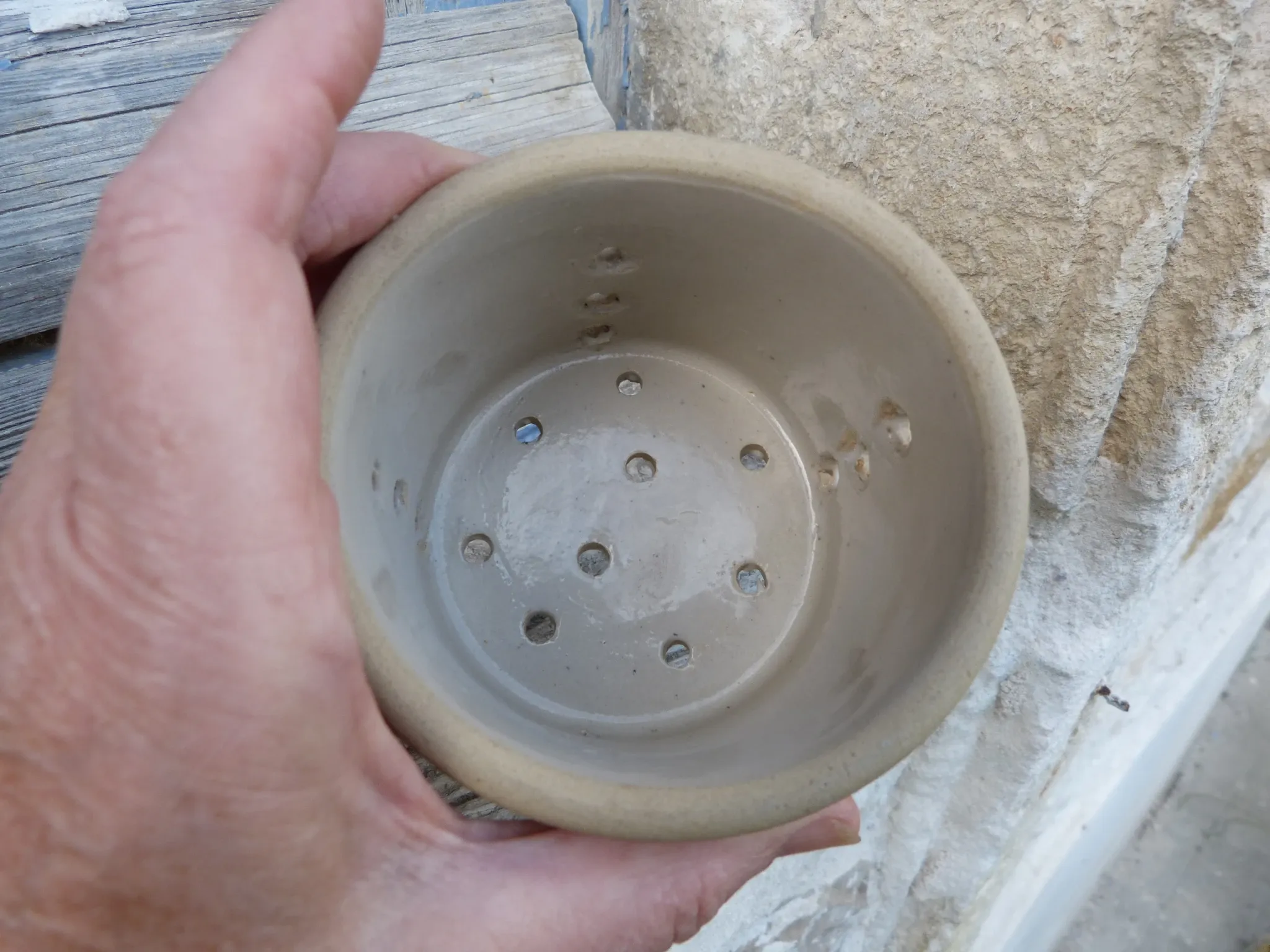 Beige stoneware cheese drainer
