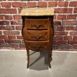 Wooden bedside table topped with a pink marble top