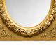 Large Louis XVI style mirror in gilded wood and composition – Early 20th century.