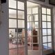 Triptych glass door with three panels featuring small panes. Vintage.