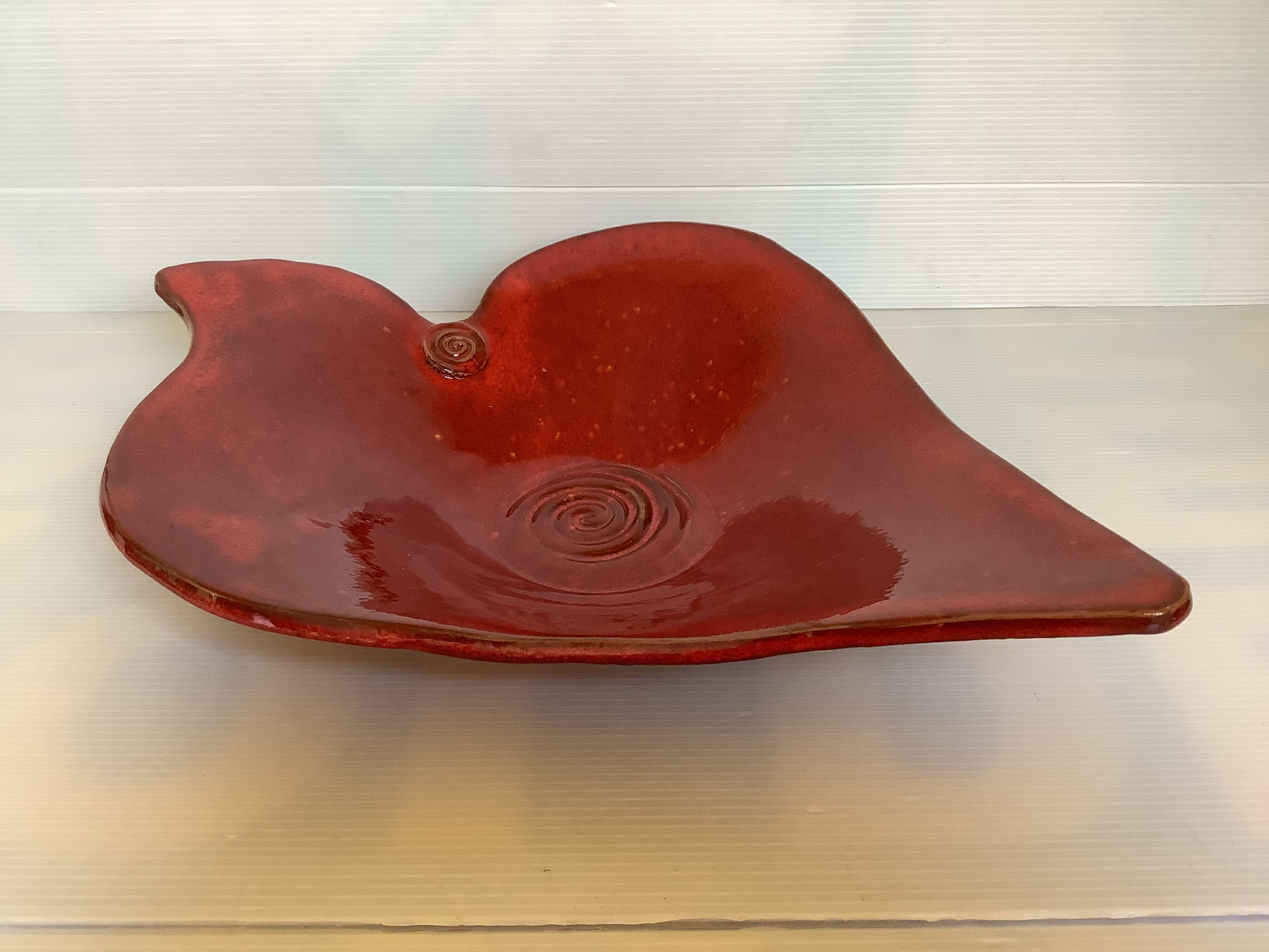 Red terracotta spiral pattern fruit bowl