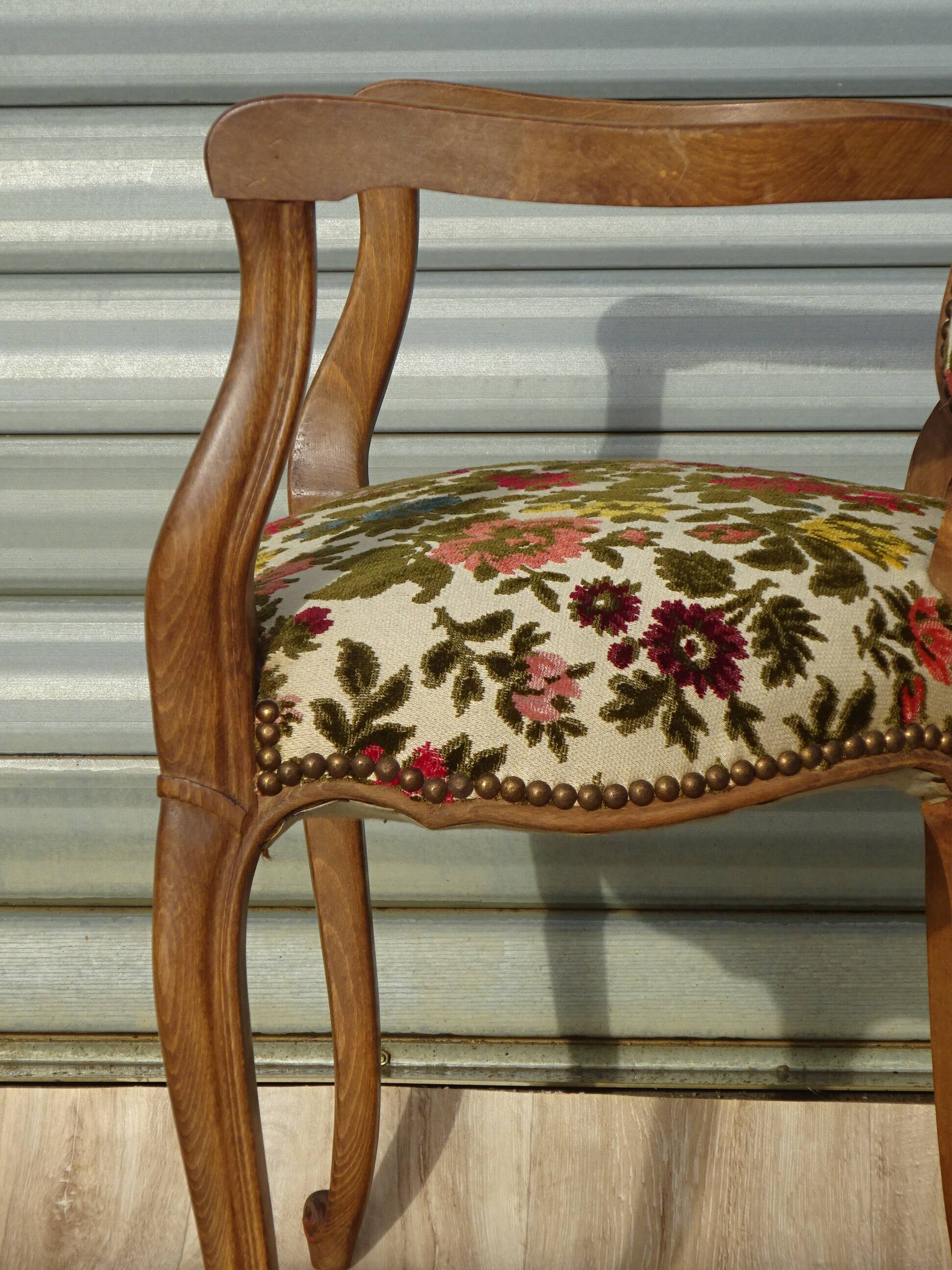 Convertible armchair with brocade fabric and floral patterns.