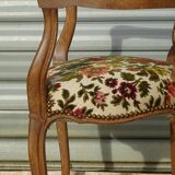 Convertible armchair with brocade fabric and floral patterns.