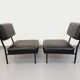 Set of 2 vintage modernist armchairs in black faux leather and metal.