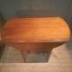 Drop-leaf table with 6 legs and 3 extensions.
