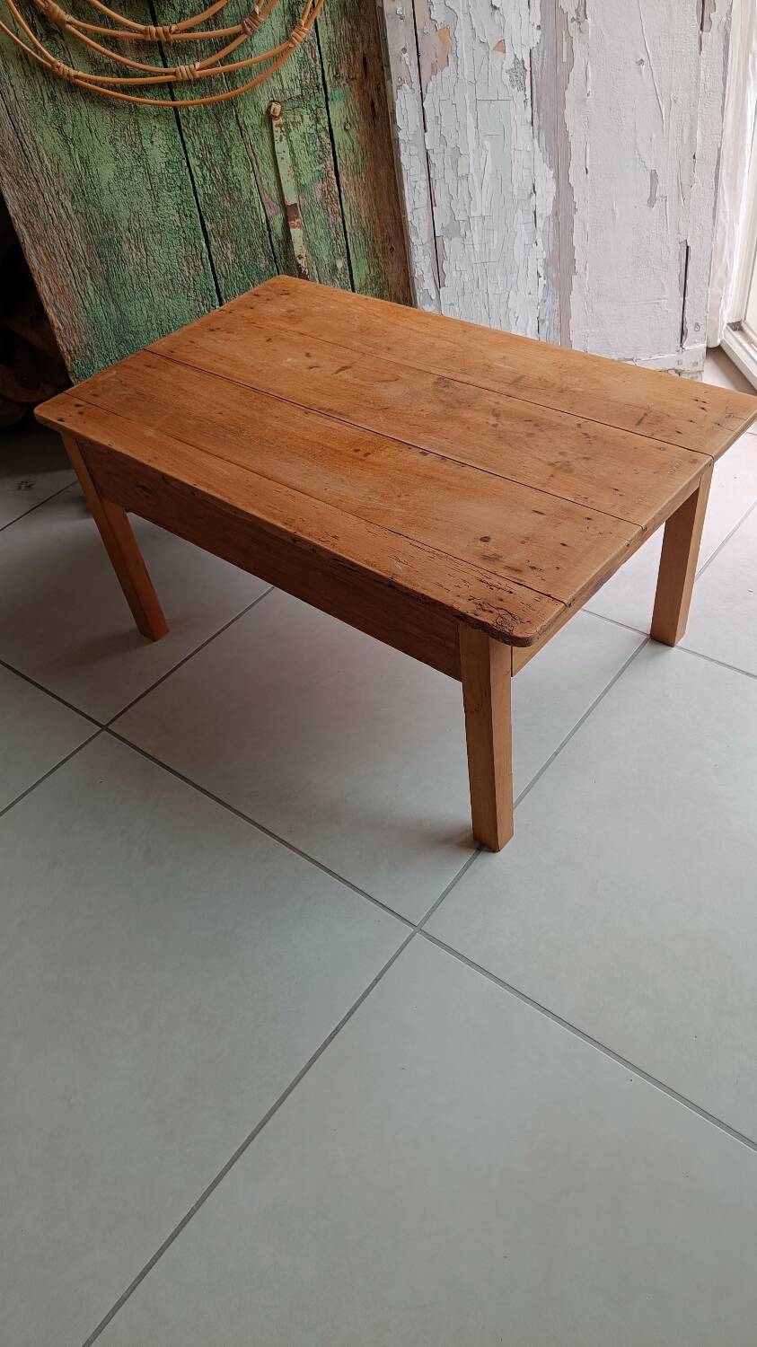 Coffee table with raw wood and a large drawer.