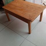 Coffee table with raw wood and a large drawer.