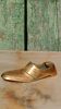 Vintage brass ashtray in the shape of a shoe.