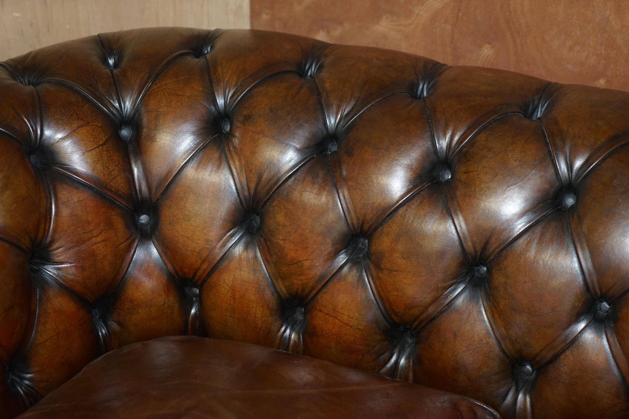 Restored leather Chesterfield sofa, walnut legs.