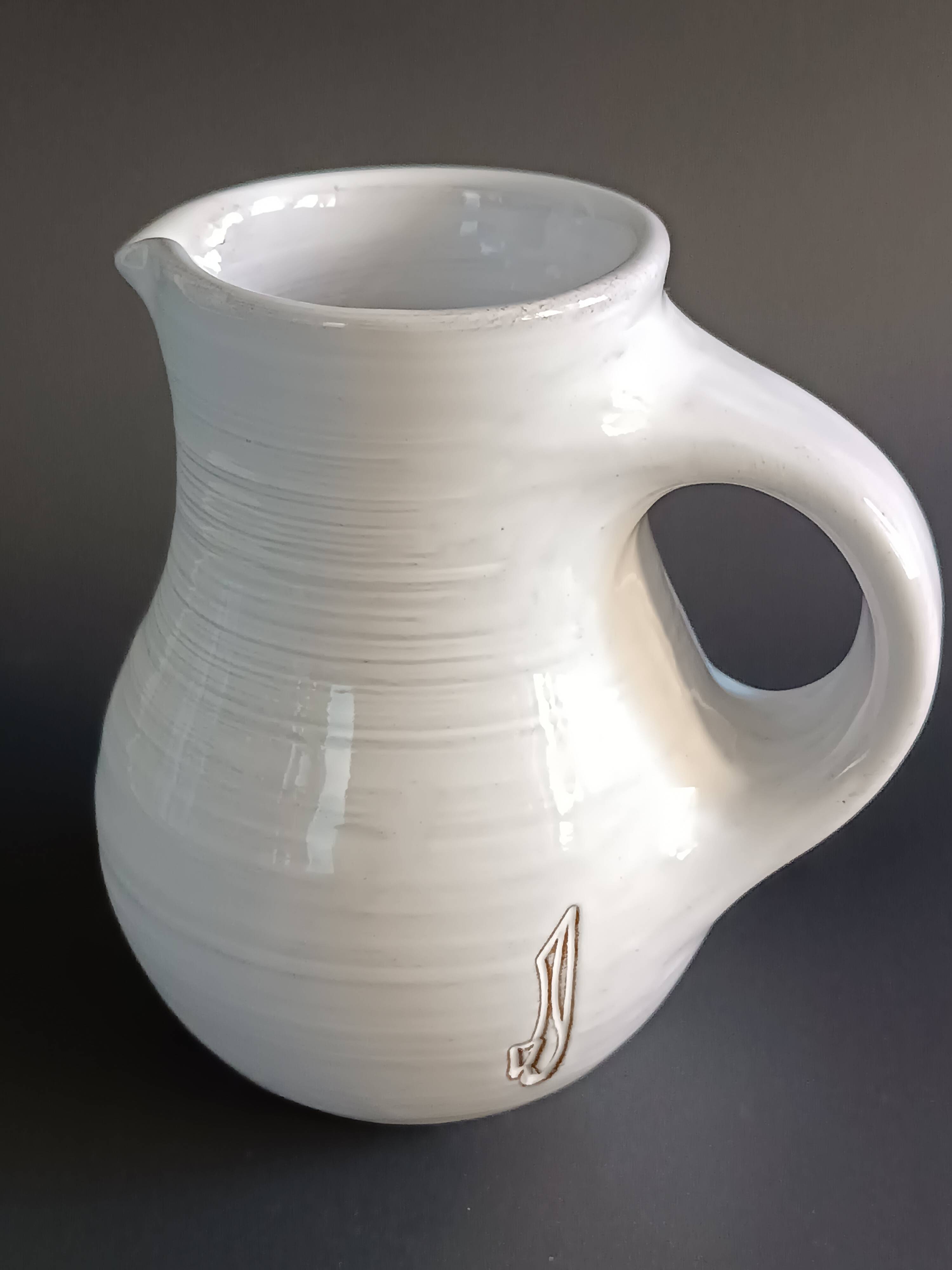 Vintage white glazed ceramic pitcher signed